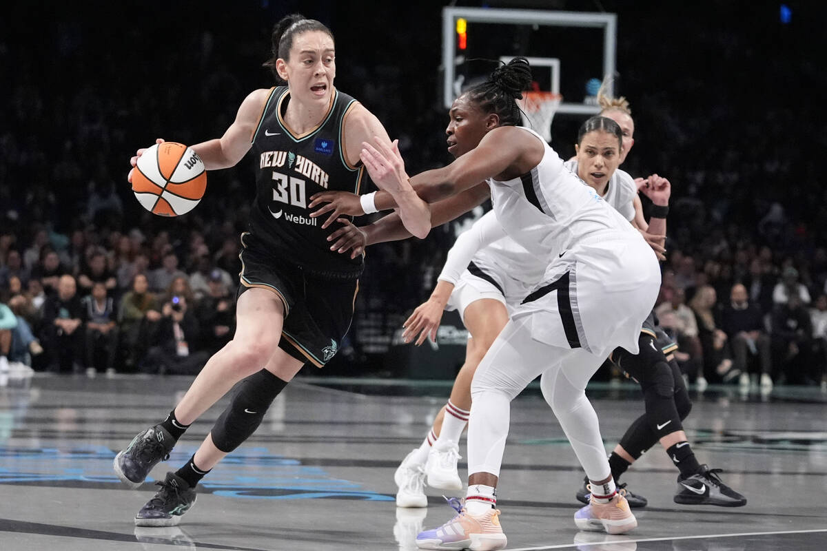 New York Liberty's Breanna Stewart (30) drives past Las Vegas Aces' Chelsea Gray (12) during th ...