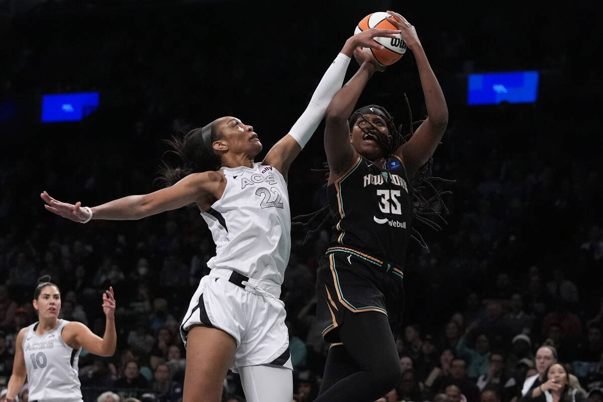 Las Vegas Aces' A'ja Wilson (22) defends a shot by New York Liberty's Jonquel Jones (35) during ...