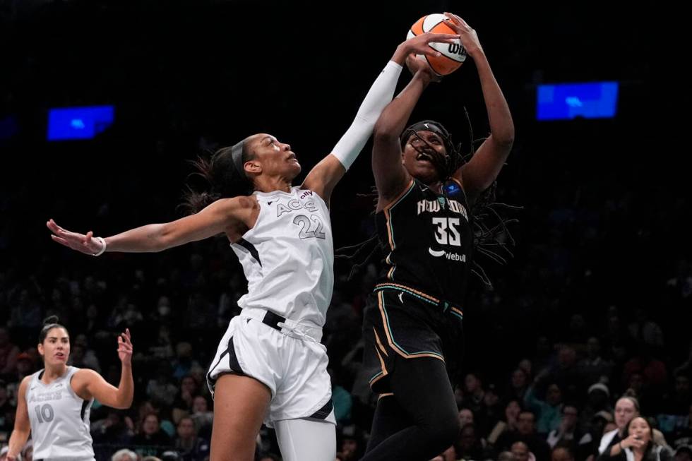 Las Vegas Aces' A'ja Wilson (22) defends a shot by New York Liberty's Jonquel Jones (35) during ...