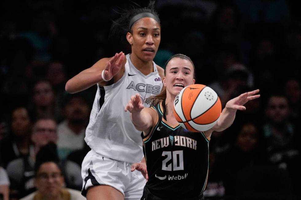 New York Liberty's Sabrina Ionescu (20) passes away from Las Vegas Aces' A'ja Wilson (22) durin ...