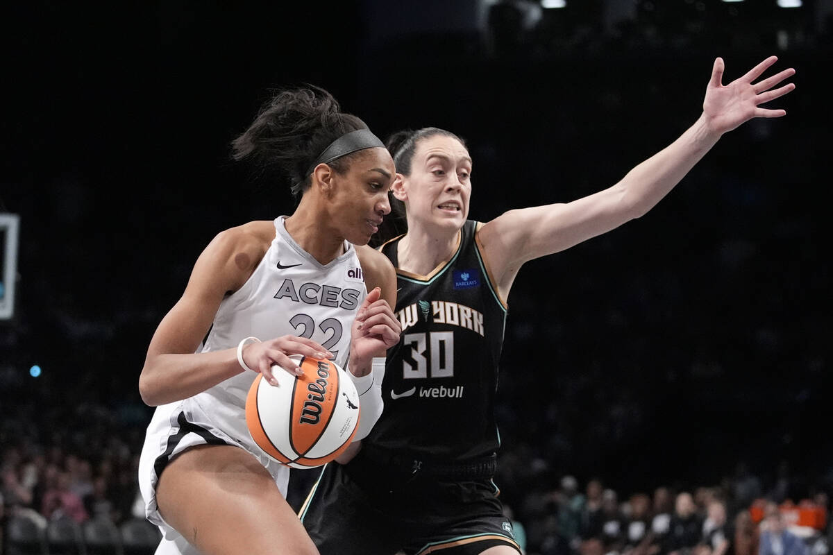 New York Liberty's Breanna Stewart (30) defends Las Vegas Aces' A'ja Wilson (22) during the sec ...