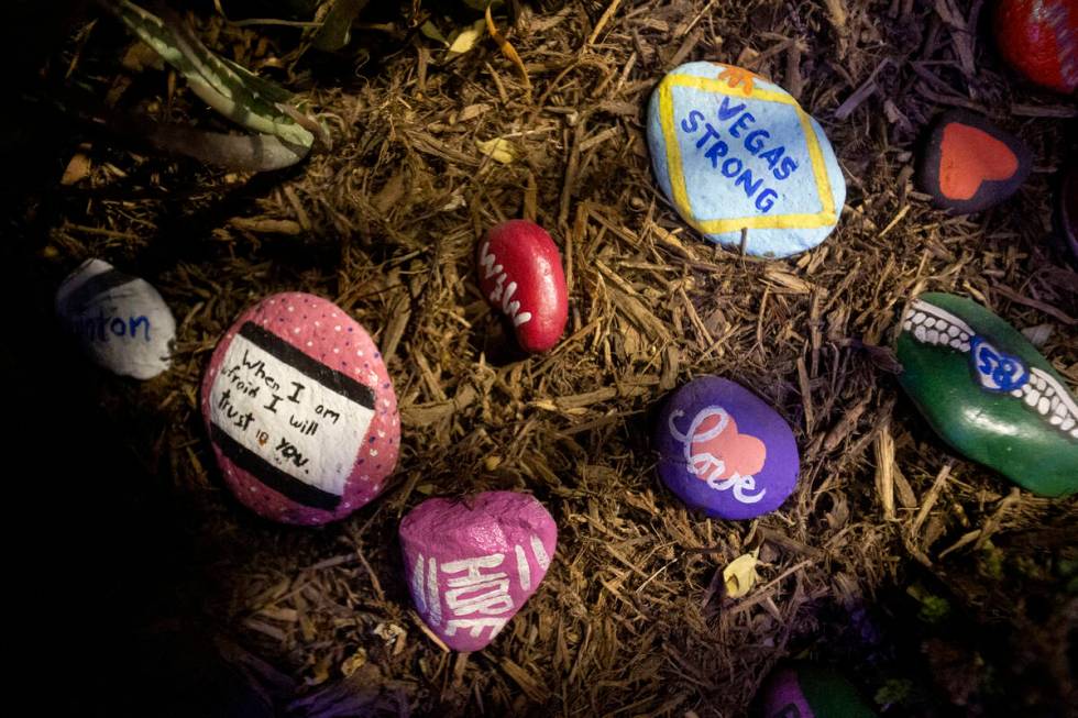 Painted rocks are placed throughout the garden to remember those who perished during the events ...