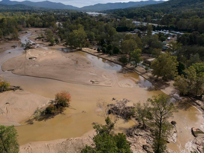 Water is seen outside the banks of the Swannanoa river in the aftermath of Hurricane Helene, Tu ...