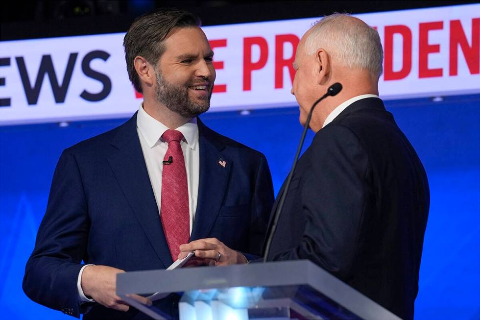 Republican vice presidential nominee Sen. JD Vance, R-Ohio, talks with Democratic vice presiden ...