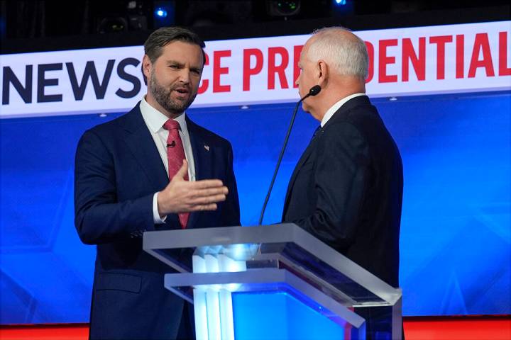 Republican vice presidential nominee Sen. JD Vance, R-Ohio, talks with Democratic vice presiden ...