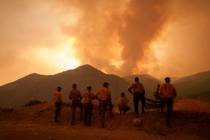 FILE - Firefighters monitor the advancing Line Fire in Angelus Oaks, Calif., Monday, Sept. 9, 2 ...