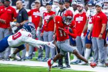 UNLV wide receiver Ricky White III (11) gets past Fresno State defensive back Kosi Agina (10) f ...