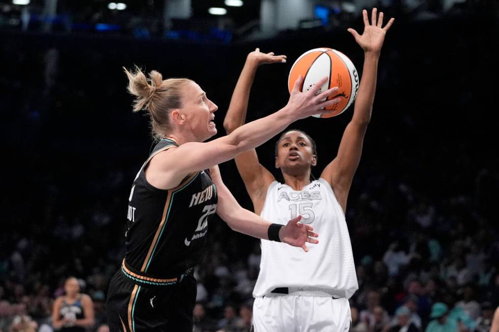 New York Liberty's Courtney Vandersloot (22) shoots over Las Vegas Aces' Tiffany Hayes (15) dur ...