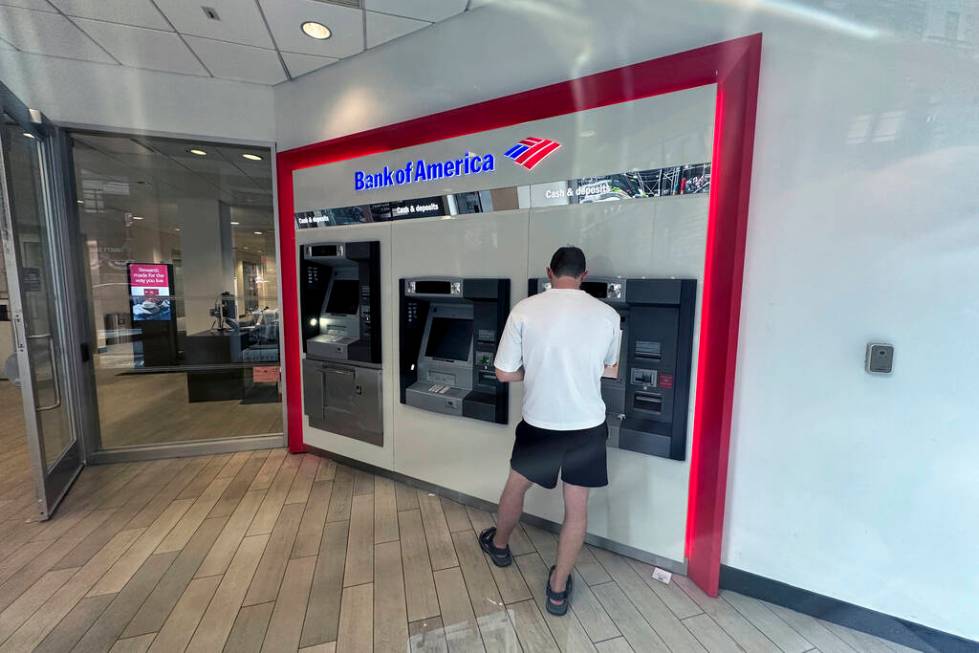 A person uses a Bank of America ATM in New York on Friday, August 2, 2024. (AP Photo/Ted Shaffrey)