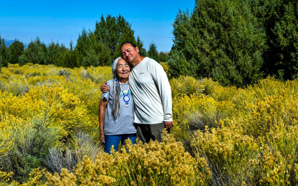 Delaine and Rick Spilsbury stand among Bahsahwahbee, a grove of Rocky Mountain juniper trees lo ...