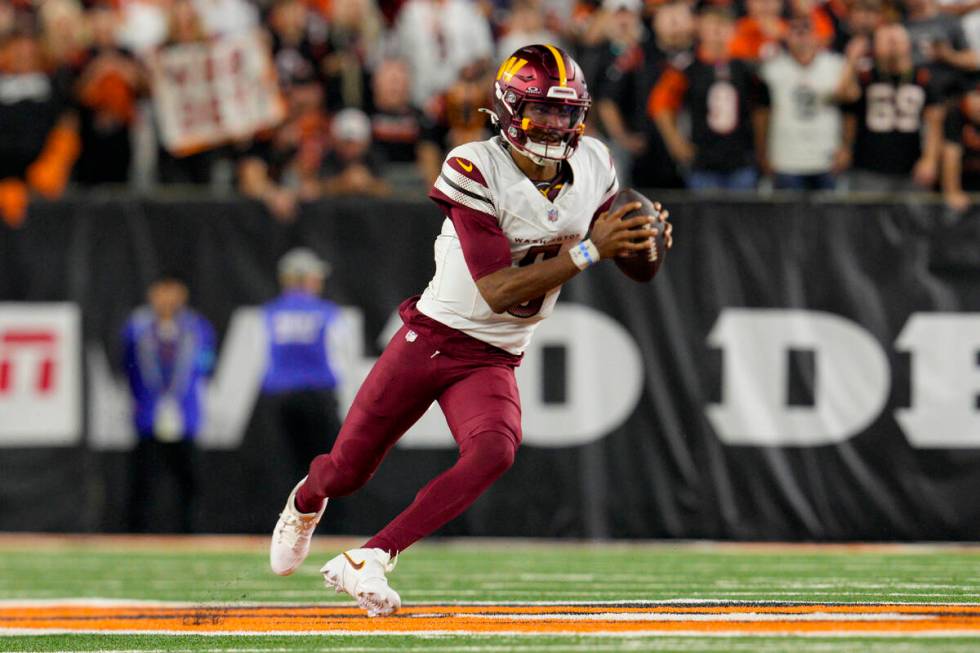 Washington Commanders quarterback Jayden Daniels (5) plays during an NFL football game against ...