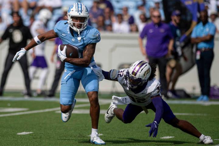 North Carolina wide receiver Kobe Paysour (8) escapes from James Madison cornerback DJ Barksdal ...