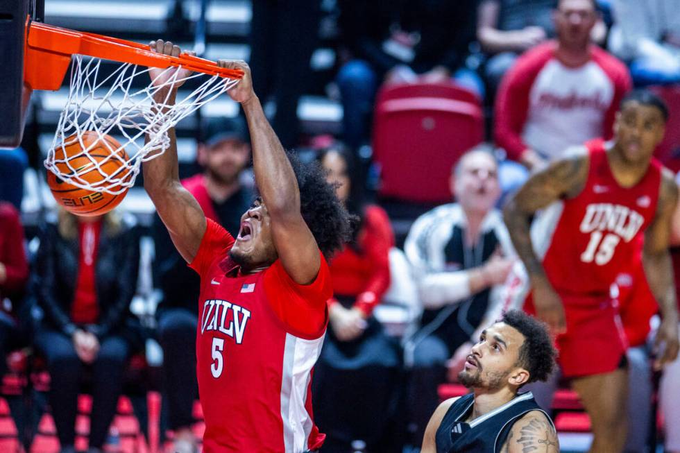 UNLV Rebels forward Rob Whaley Jr. (5) dunks the ball as UNR forward K.J. Hymes (42) looks on d ...