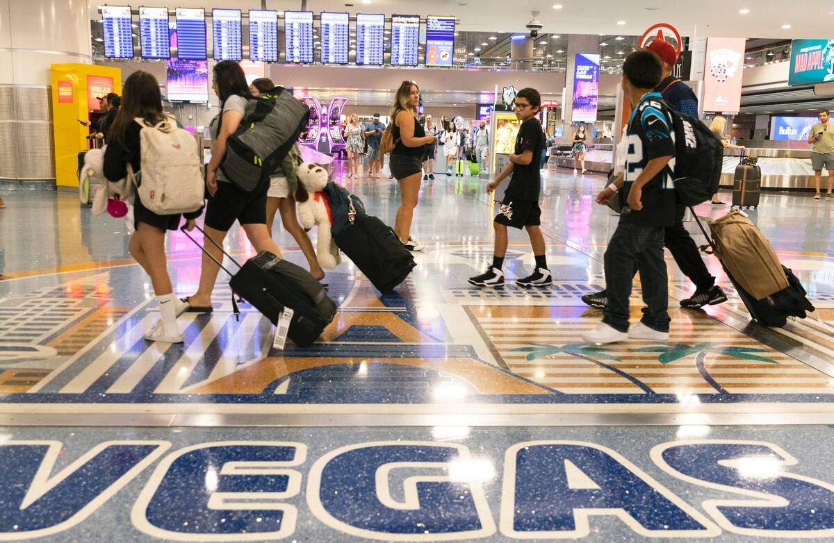 Arriving passengers head to baggage claim area at Terminal 1 of Harry Reid International Airpor ...