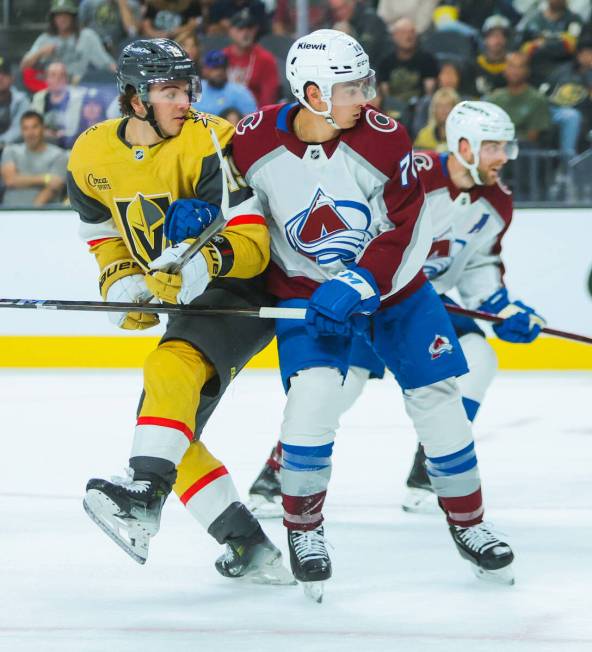 Golden Knights center Brendan Brisson (19) and Colorado Avalanche defenseman Sam Malinski (70) ...