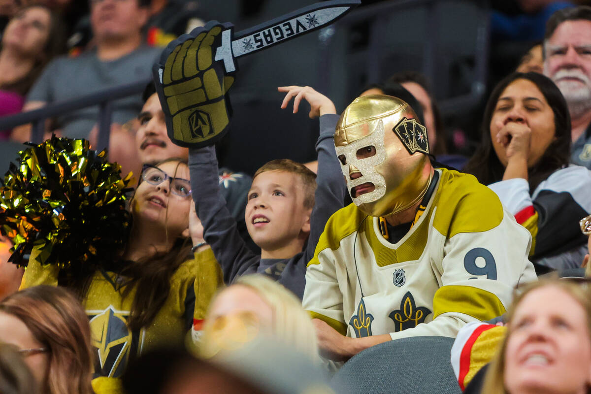 A Golden Knights fan watches game action during the third period of a preseason NHL hockey game ...