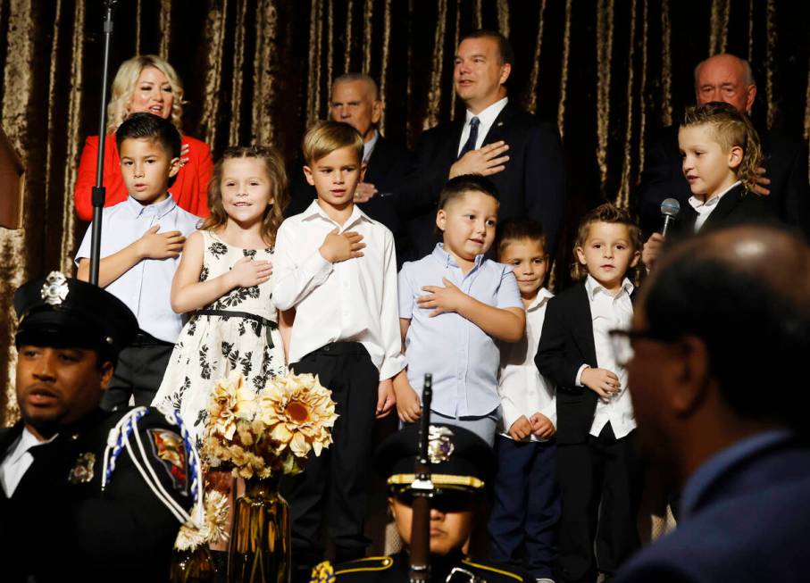 Henderson Mayor Michelle Romero, top left, watches as her grandchildren recite the Pledge of Al ...