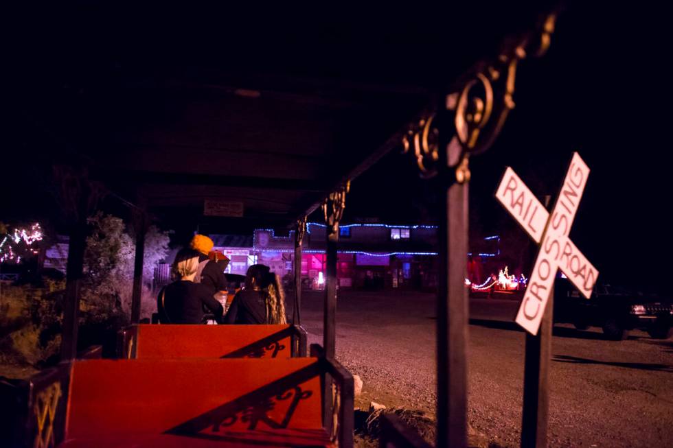 Visitors take a train from the parking lot to "Bonnie Screams" at Bonnie Springs Ranch outside ...