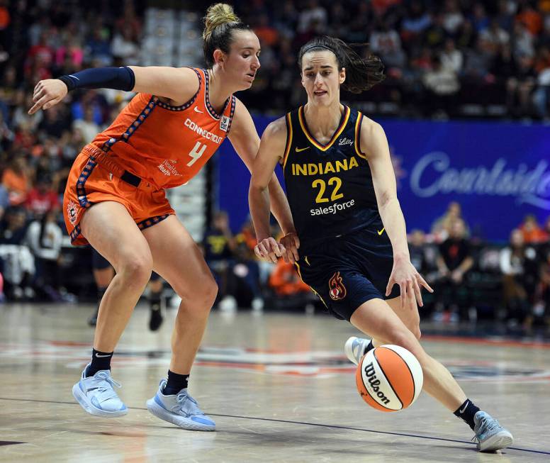 Connecticut Sun's Marina Mabrey (4) guards against Indiana Fever's Caitlin Clark (22) during a ...