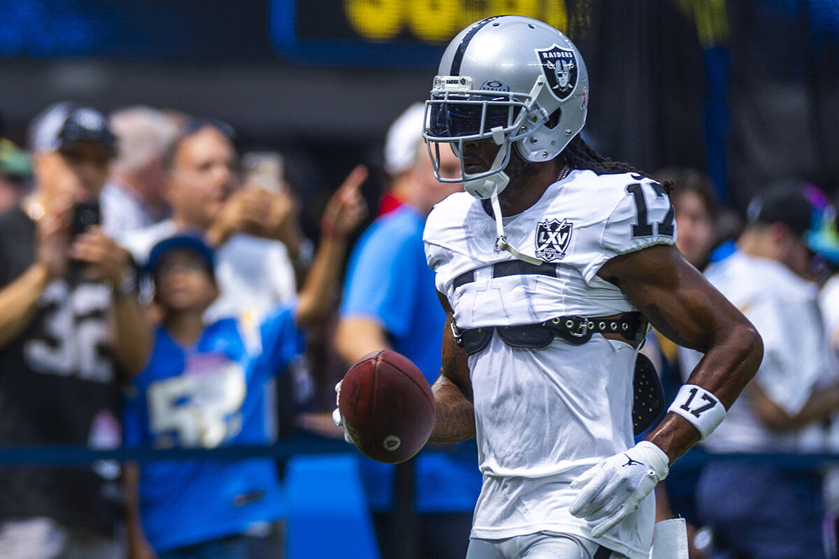 Raiders wide receiver Davante Adams (17) runs with the ball as they warm up to face the Los Ang ...