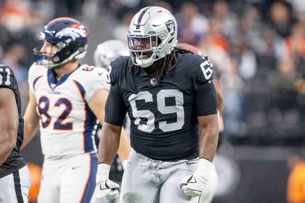 Raiders defensive tackle Adam Butler (69) reacts after a big defensive play against the Denver ...