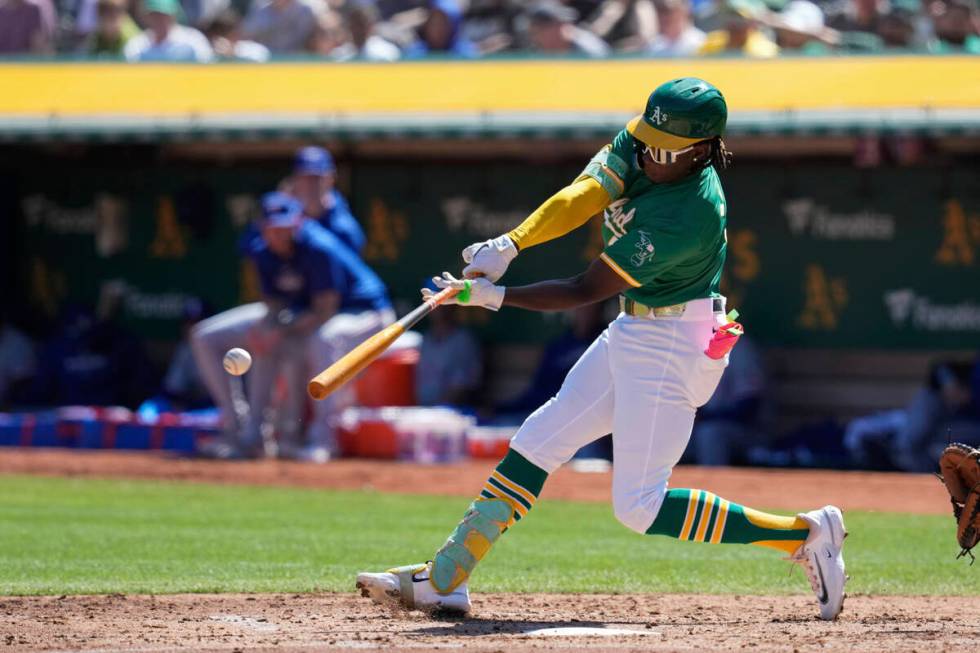 Oakland Athletics' Lawrence Butler hits a single during the third inning of a baseball game aga ...