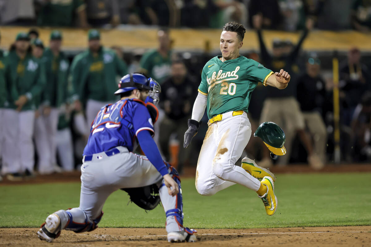 Oakland Athletics' Zack Gelof (20) scores the game-winning run on a RBI single by Jacob Wilson ...