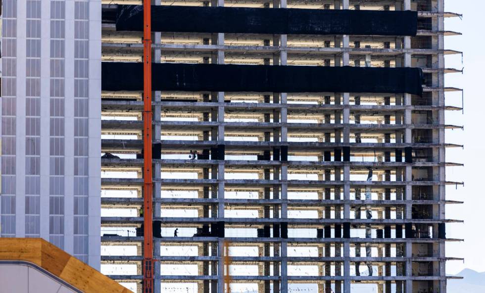 A worker walks along a floor of the rear tower as preparations for the upcoming implosion conti ...