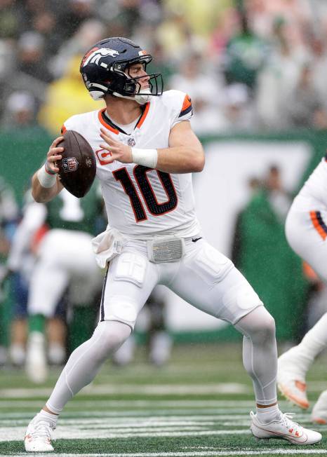 Denver Broncos quarterback Bo Nix (10) looks to pass during an NFL football game against the Ne ...