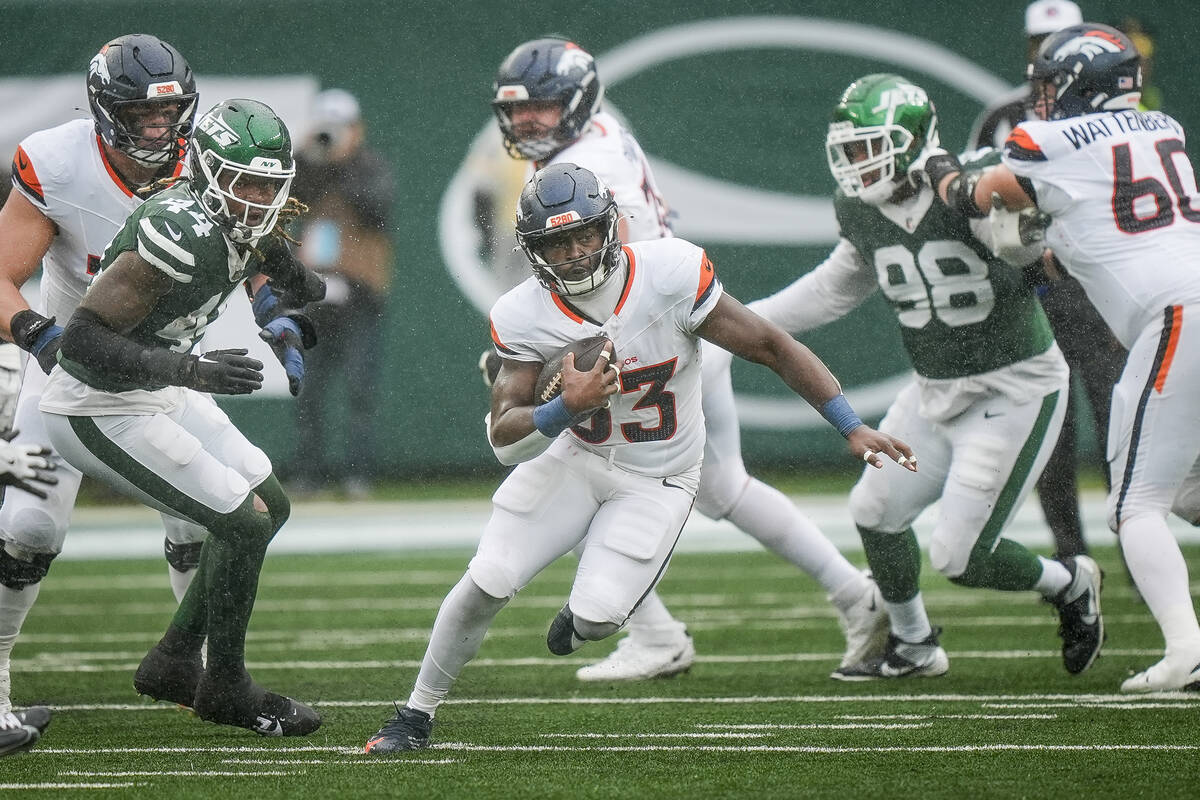 Denver Broncos running back Javonte Williams (33) runs with the ball during an NFL football gam ...