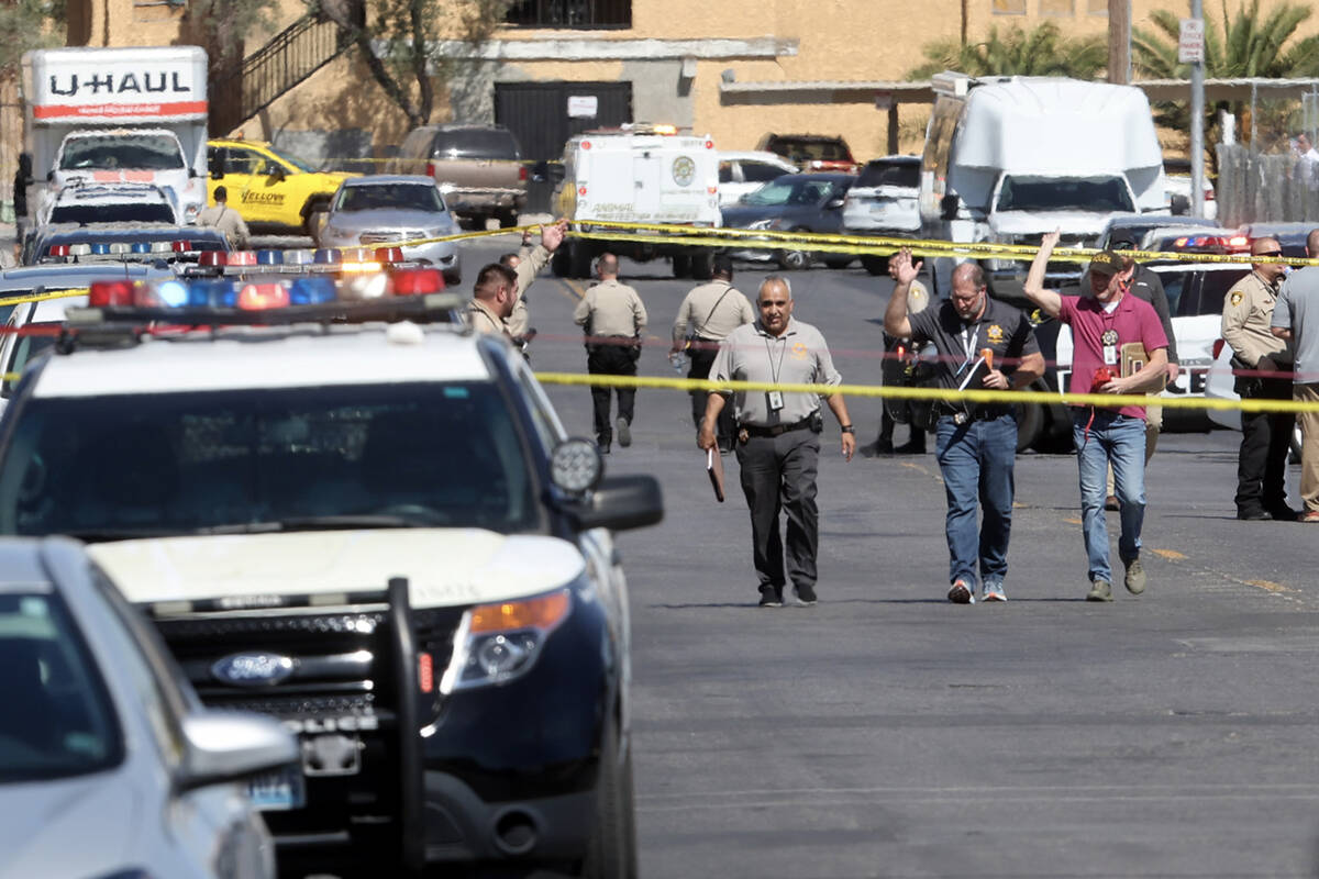 Las Vegas police investigate the scene of a officer-involved shooting on Deckow Lane near Tropi ...