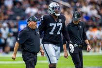 Raiders offensive tackle Thayer Munford Jr. (77) is escorted off the field after a possible leg ...