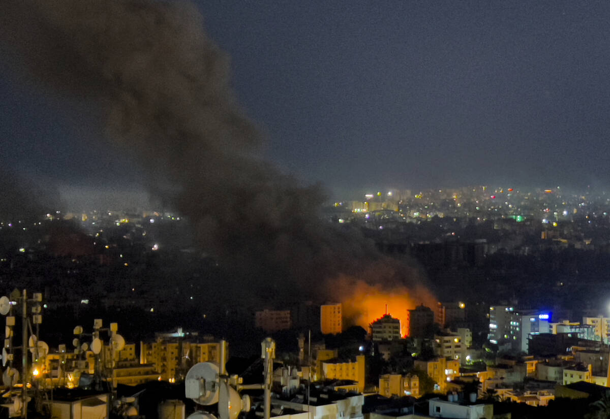 Flames and smoke rise from Israeli airstrikes in Dahiyeh, Beirut, Lebanon, Friday, Oct. 4, 2024 ...