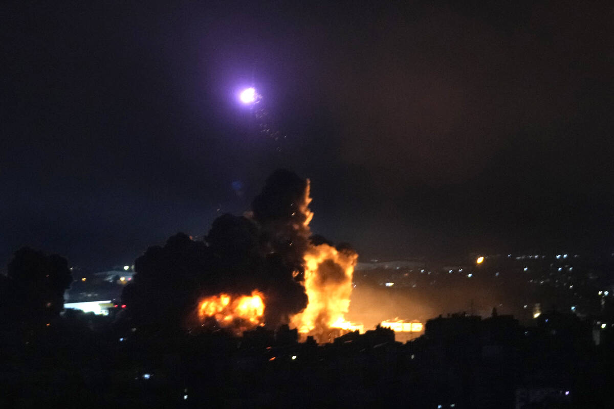 Flames rise from Israeli airstrikes in Dahiyeh, Beirut, Lebanon, Friday, Oct. 4, 2024. (AP Phot ...