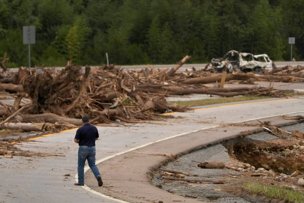 A person walks on Interstate 26 as debris covers the roadway in the aftermath of Hurricane Hele ...