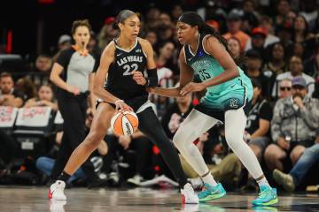 Aces center A'ja Wilson (22) dribbles the ball as New York Liberty forward Jonquel Jones (35) g ...