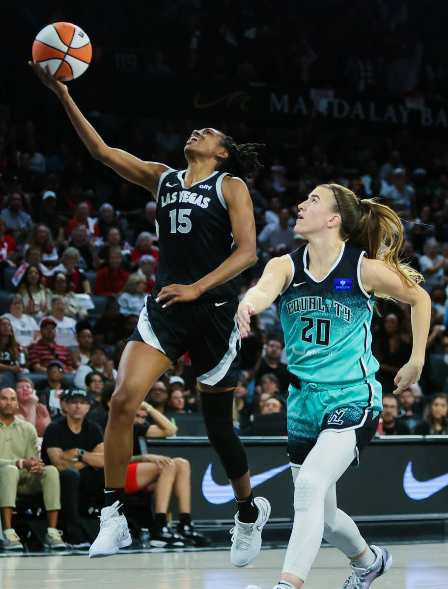 Aces guard Tiffany Hayes (15) goes for a layup as New York Liberty guard Sabrina Ionescu (20) d ...