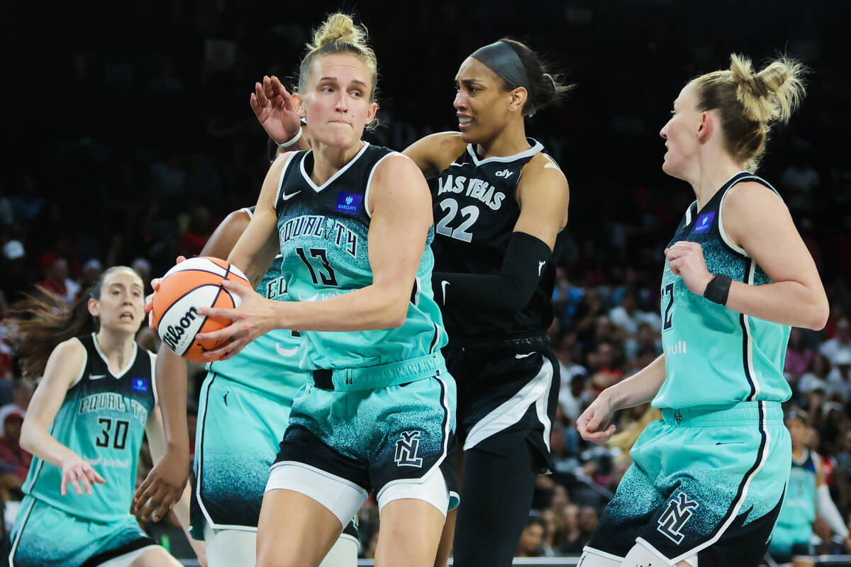 New York Liberty forward Leonie Fiebich (13) keeps the ball in her possession as Aces center A' ...