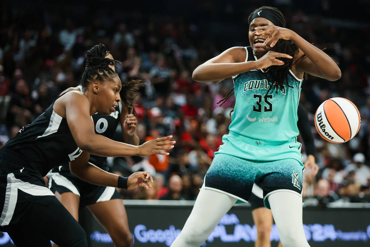 Aces guard Chelsea Gray (12) forces New York Liberty forward Jonquel Jones (35) to lose possess ...