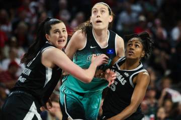 Aces guard Tiffany Hayes (15) and center Megan Gustafson (17) hold back New York Liberty forwar ...