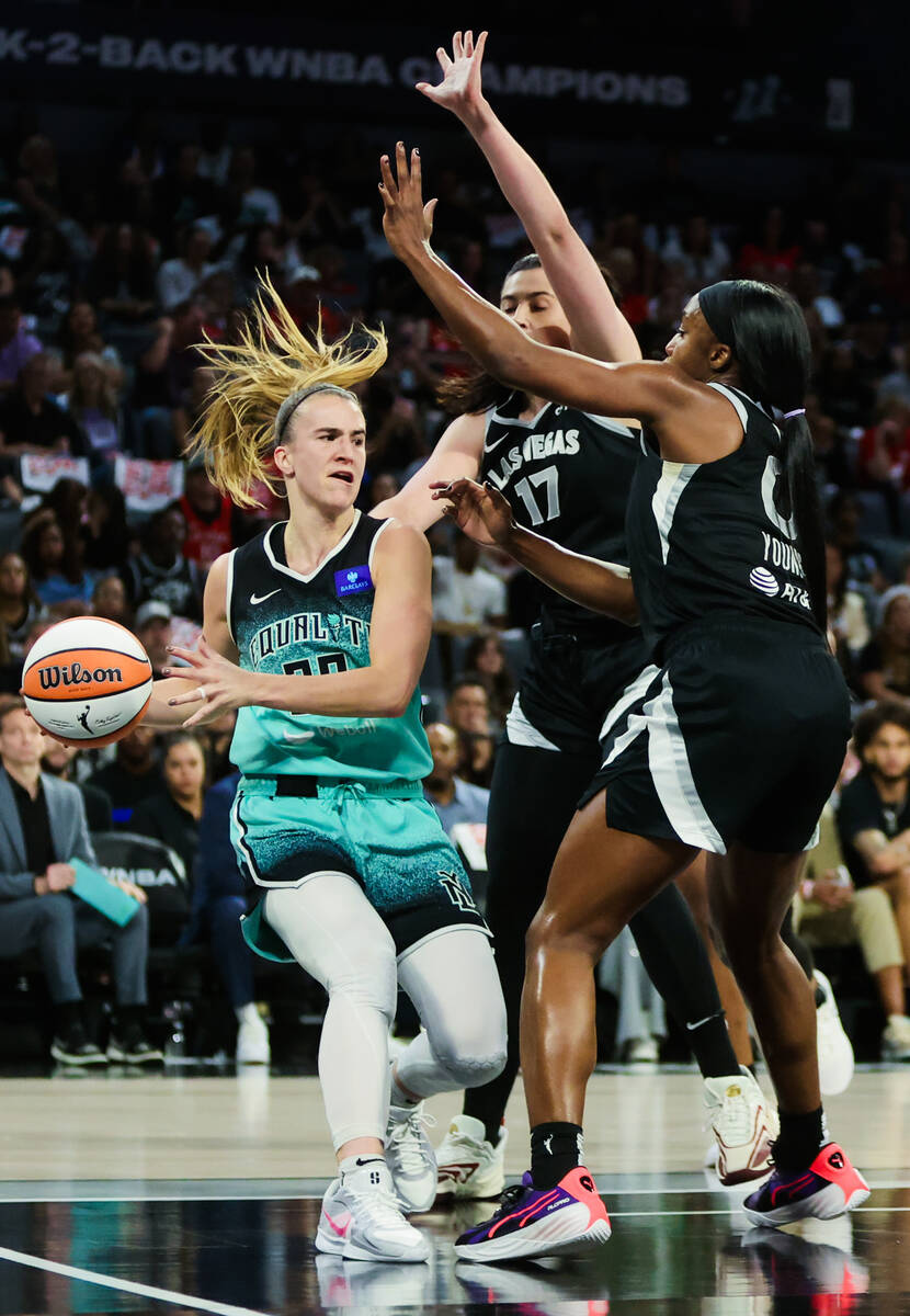 New York Liberty guard Sabrina Ionescu (20) drives the ball into the paint while Aces guard Jac ...