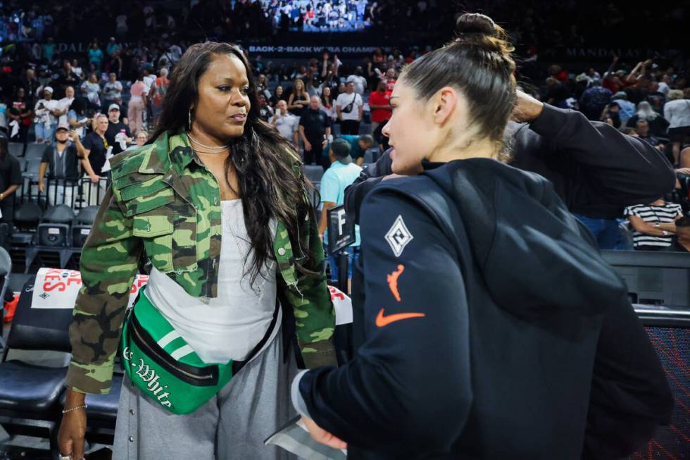 WNBA Sheryl Swoopes, left, speaks to Aces guard Kelsey Plum following game three of a WNBA semi ...