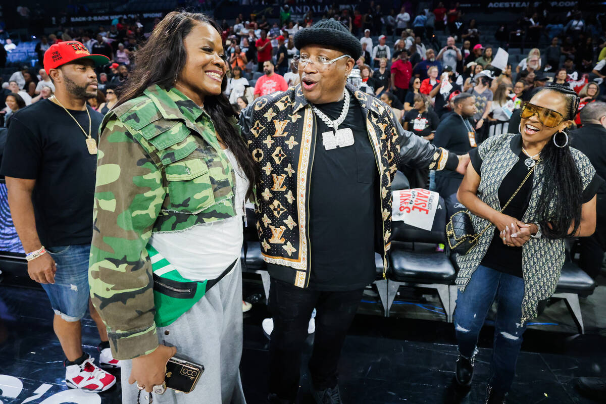 WNBA legend Sheryl Swoopes, left, speaks to rapper E-40, middle, following game three of a WNBA ...