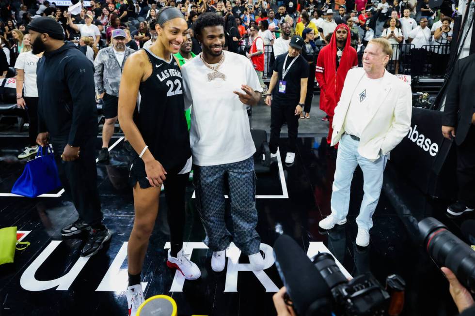 Aces center A'ja Wilson, left, poses for photographs with Colorado Buffaloes quarterback Shedeu ...