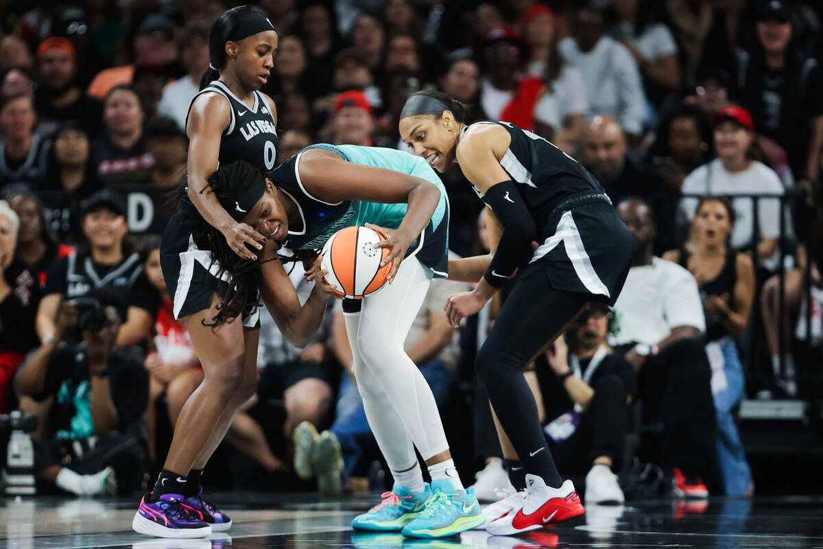 New York Liberty forward Jonquel Jones (35) gets low to avoid losing the ball to Aces guard Jac ...