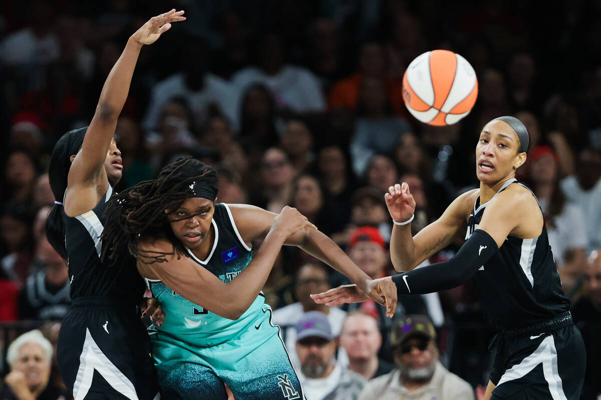 New York Liberty forward Jonquel Jones (35) throws the ball to a teammate as Aces guard Jackie ...