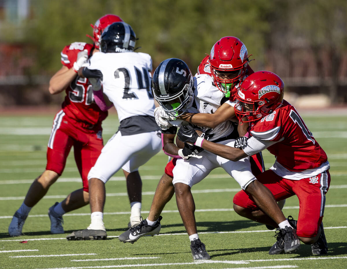 Arbor View players attempt to tackle Desert Pines junior Majik McMillion (5) during the high sc ...