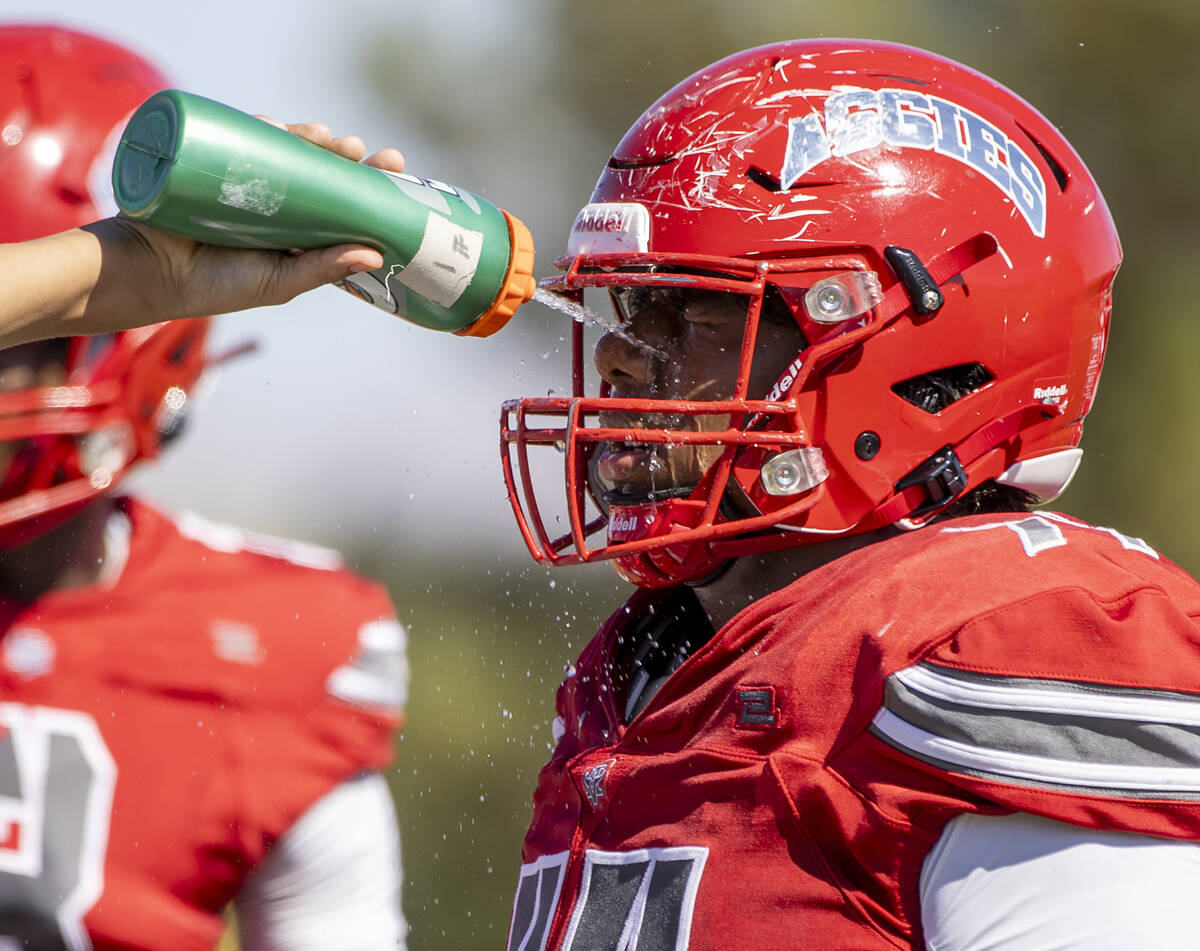 Arbor View offensive lineman Caden Terry (77) is sprayed with water during the high school foot ...