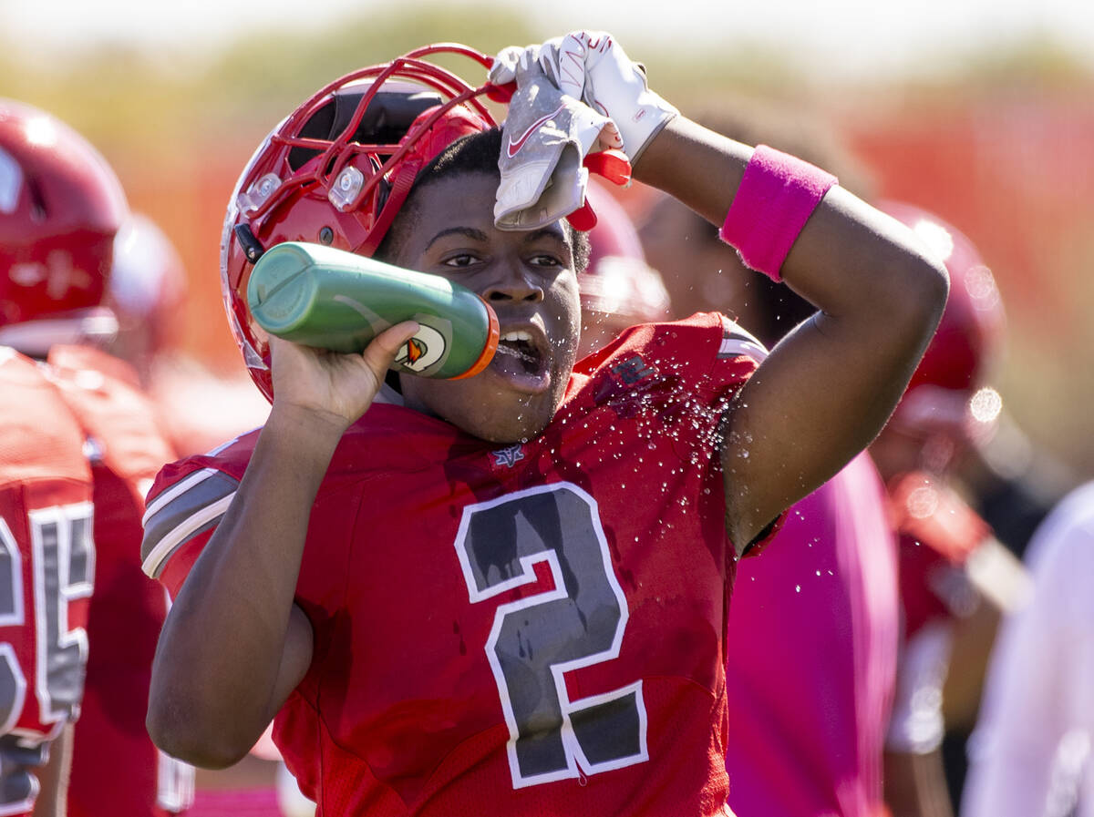 Arbor View running back Sean Moore (2) drinks water during the high school football game agains ...