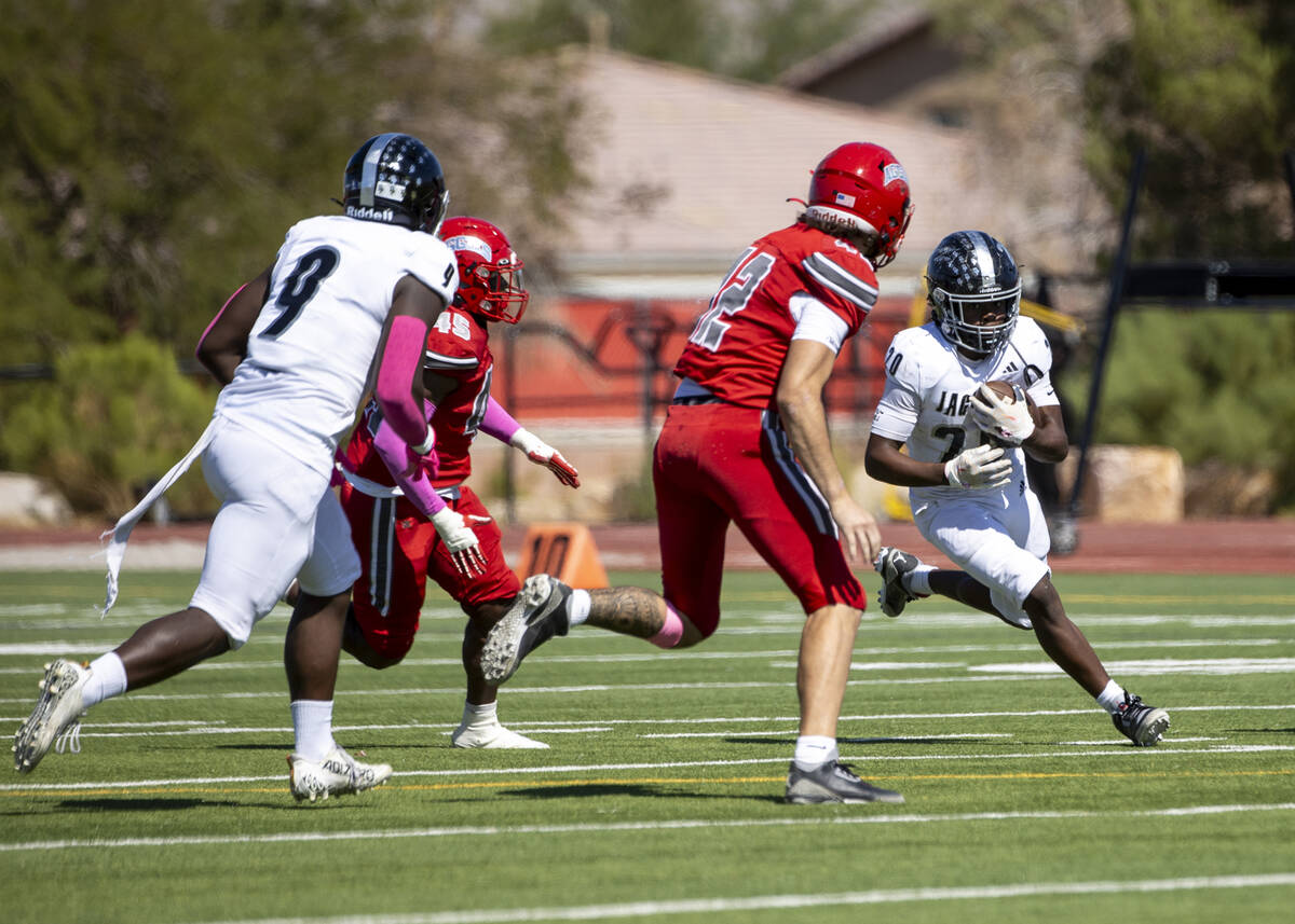 Desert Pines running back Marcus Williams (20) runs with the ball during the high school footba ...